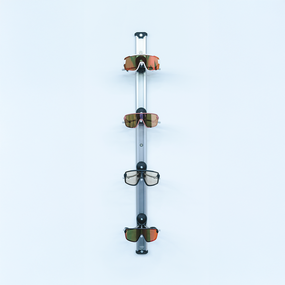 Sunglasses displayed on a vertical stand against a light blue background