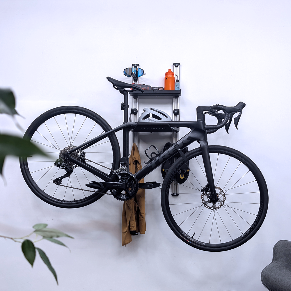 SpaceRail ONE Rail Mounted Pro Set holding a road bike with cycling kit alongside