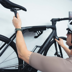 Angled view of the SpaceRail ONE single bike wall mount with a road bike